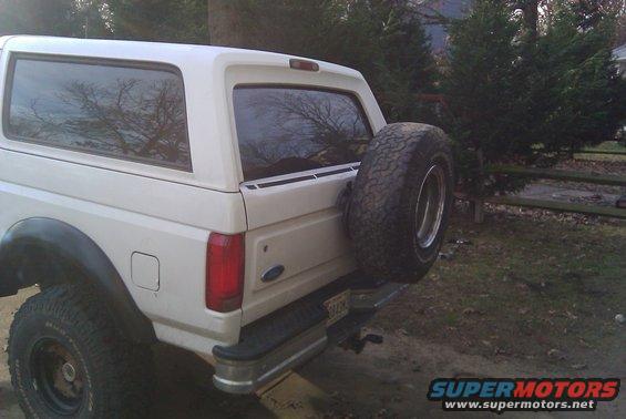Rear view of a white 1996 Ford Bronco with a spare tire on the tailgate