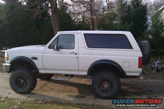 White 1996 Ford Bronco lifted with off-road tires, side view