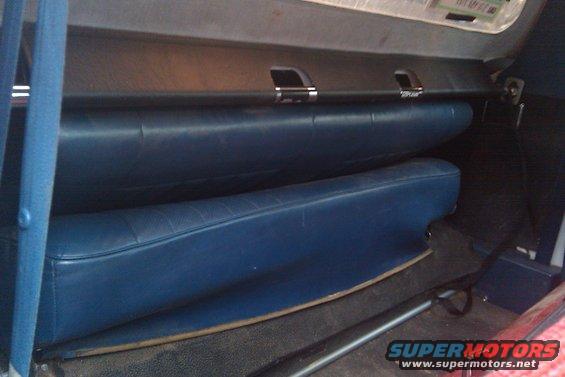 Interior shot of a vehicle showing blue seats and a dark dashboard area