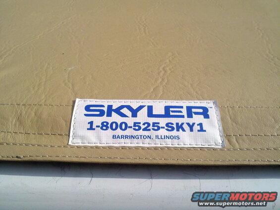 Tan car cover with a white label showing "SKYLER 1-800-525-SKY1 Barrington, Illinois"