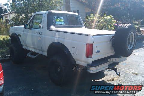 White 1996 Ford Bronco with soft top and spare tire on rear