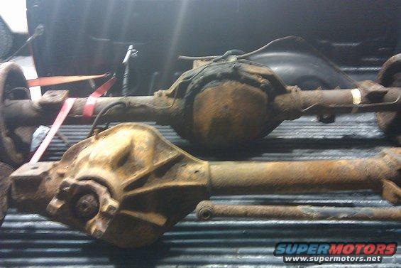 two rusty truck axles in a truck bed