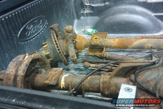 rusted Ford truck axles in a pickup bed