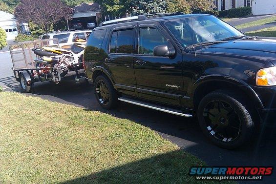 Black 2005 Ford Explorer towing a trailer with jet skis