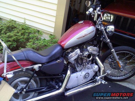 Red and silver Harley-Davidson motorcycle with "Harley-Davidson" text on the tank