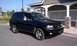 2008 Chevrolet TrailBlazer - A black 2008 Chevrolet TrailBlazer is parked outside a building with a covered entrance.