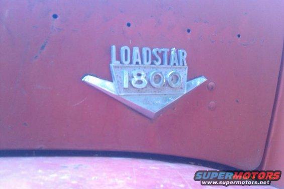 Close-up of a red vehicle's 'Loadstar 1800' badge