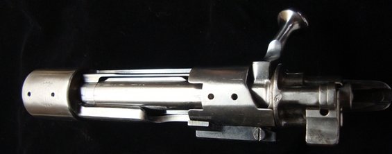 Bolt action rifle mechanism with polished metal finish and prominent bolt handle