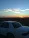 1996 Mercury Grand Marquis - A white 1996 Mercury Grand Marquis is seen from the rear with a sunset in the background.