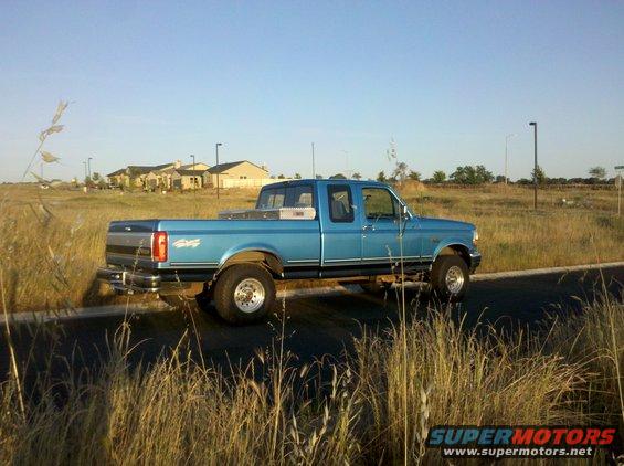Blue 1992 Ford F-150 pickup truck parked on the side of a road