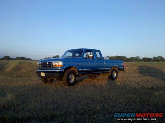 Blue 1992 Ford F-150 pickup truck parked in a grassy field