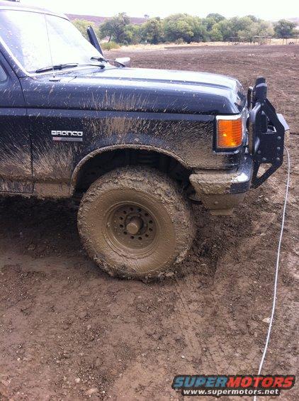 Mud-covered 1990 Ford Bronco, front quarter panel and wheel visible