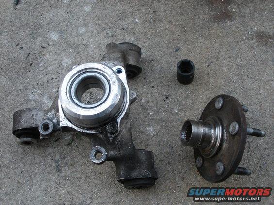 Wheel bearing assembly and separate hub with studs on concrete. Socket visible