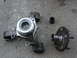 1995 Ford Thunderbird - Disassembled wheel bearing and hub assembly with a socket on a concrete surface.