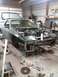 1987 Mazda RX-7 - This 1987 Mazda RX-7 is undergoing repairs in a garage, with its hood open and engine visible.