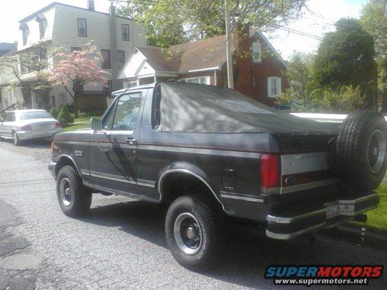 Dark SUV with soft top and rear spare tire