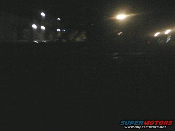 Dark scene with blurred lights and a watermark