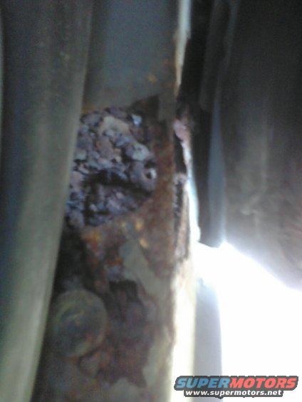 rusted frame rail with some debris