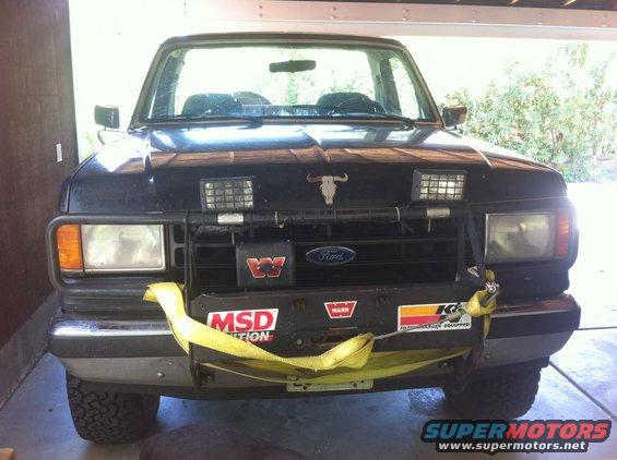 Black Ford Bronco front view with winch, auxiliary lights, and bull decal on hood