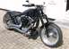 1995 Harley-Davidson Fat Boy - Motorcycle parked on a brick patio, showing its front wheel and engine details.