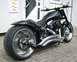 1995 Harley-Davidson Fat Boy - A custom motorcycle with a low-slung profile and extensive chrome detailing is parked outside a building.