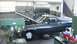 1972 Ford Ranchero - A workshop scene a pickup truck with its hood raised, parked next to a large green drill press.