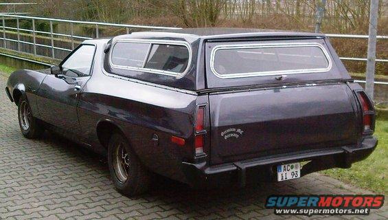 Dark purple coupe utility with camper shell, rear view. License plate AC II 93