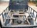 1994 Ford Explorer - The rear chassis and bed frame of a dark blue truck are visible, showing exposed mechanical components.