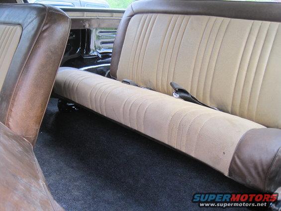 Interior view of tan and brown seats with seatbelts