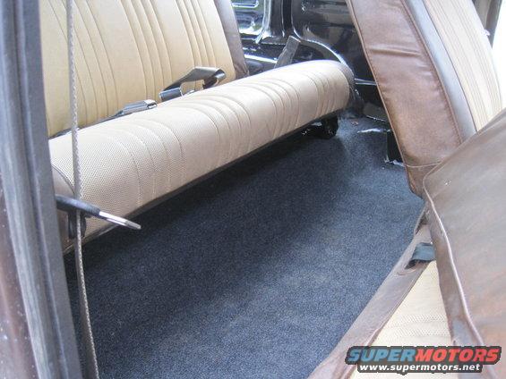 Interior view of tan and brown seats and dark carpet