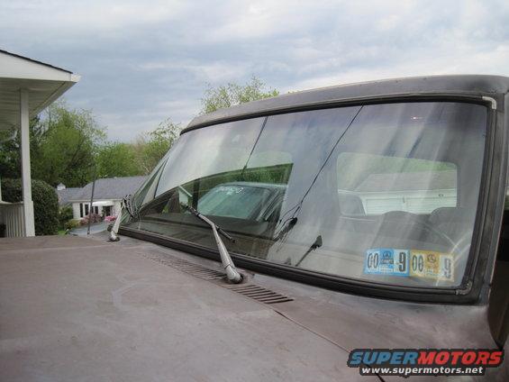 Windshield wipers and inspection stickers on a 1979 Ford Bronco dashboard