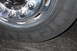 2003 Ford F-350 - A close-up shot focuses on the chrome wheel and tire of a large truck, showing the Michelin brand and tire size information.