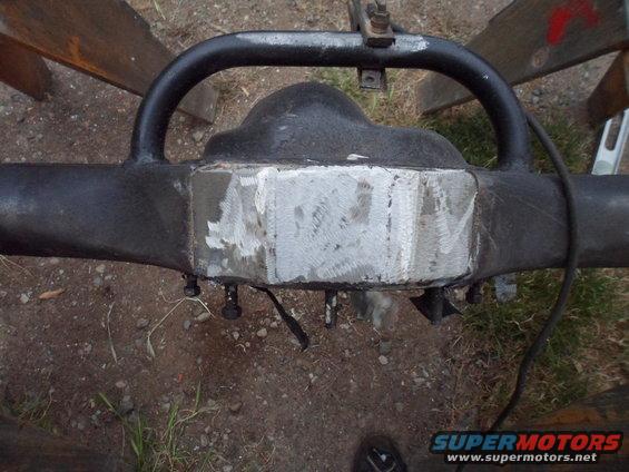 Rear axle differential housing with a freshly ground metal plate on the housing