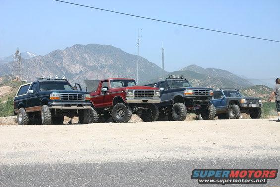 1991 Ford Bronco front 3/4 view, dark green with white top