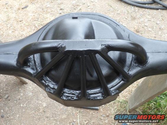 Black differential housing with a reinforced cover and support arms, viewed from the rear
