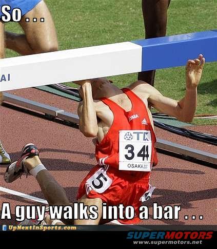 Runner tripped and fell under a hurdle during a race