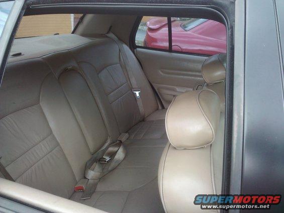 Interior rear seats of a 2001 Ford Crown Victoria, tan leather upholstery
