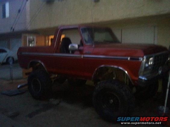 Red lifted 1978 Ford Bronco parked outside