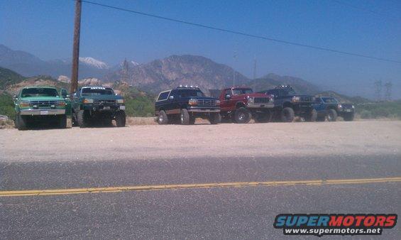 1978 Ford Bronco, black, lifted, parked in a line with other trucks