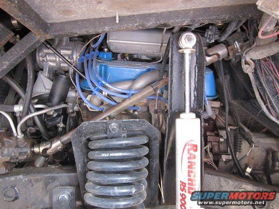 1971 Ford Bronco engine bay with blue valve covers and "Wild Horses" shocks