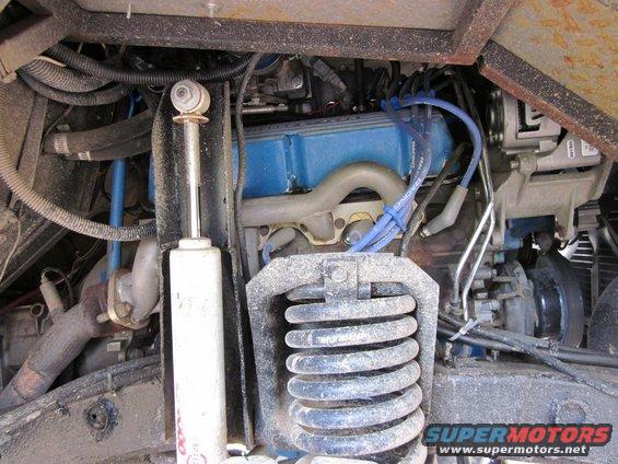 Engine bay with blue valve covers, shock absorber, and SuperMotors logo