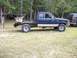 1994 Ford Explorer - This blue pickup truck features a flatbed conversion and a utility box, with a visible 1994 badge.