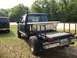1994 Ford Explorer - A modified pickup truck with a flatbed and a rifle mounted in the bed is seen next to an SUV.