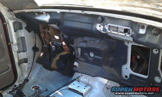 Disassembled vehicle interior showing dashboard structure and exposed components