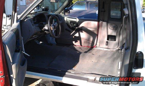 1992 Ford Ranger interior with aftermarket steering wheel and empty cab