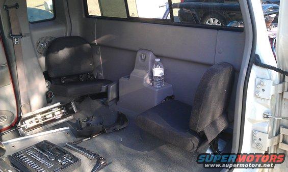 Interior of a 1992 Ford Ranger cab with jump seats and tools