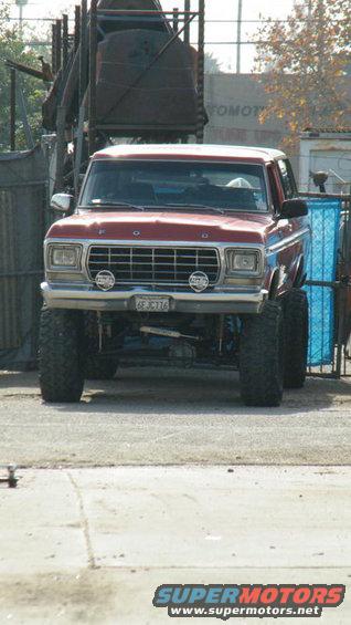 Red 1978 Ford Bronco front view with lifted suspension and large tires