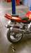 2003 Suzuki SV1000S - Rear view of an orange motorcycle dual Yoshimura exhaust pipes and a custom tail section.
