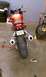 2003 Suzuki SV1000S - Rear view of a red 2003 Suzuki SV1000S motorcycle parked indoors with tools nearby.
