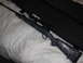1991 Ford Bronco - A rifle with a scope is shown in its case, placed on a white comforter.
